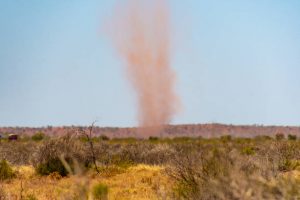 Red landspout whirlwind sand tornado dust devil in Australian dessert